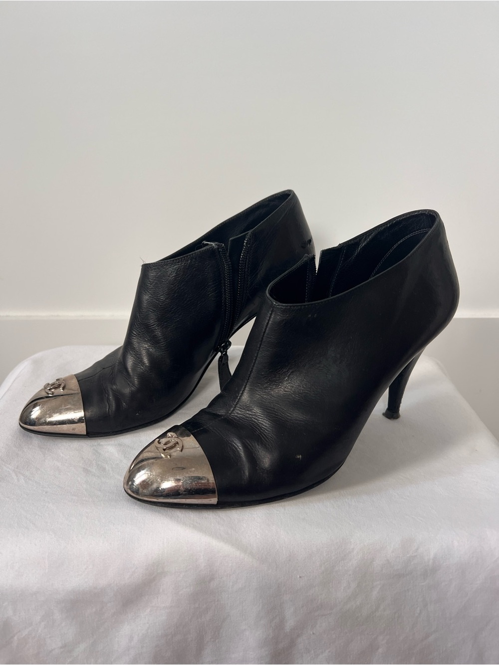 CHANEL Black Leather Ankle Booties with Silver Cap Toe and CC Logo